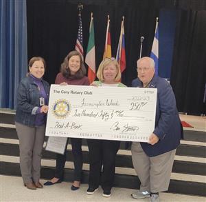 Principal Pierce and Emily Dean, Literacy Coach, accept a $250 check from representatives.